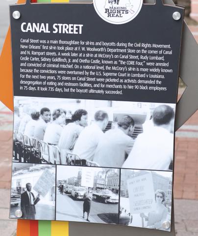 close up of historical panel depicting four photos of people taking part in Canal Street demonstrations