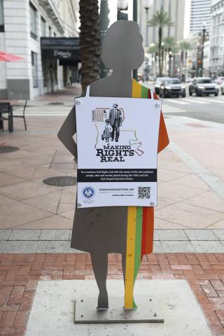 metal fabricated female silhouette protesting on Canal Street in New Orleans